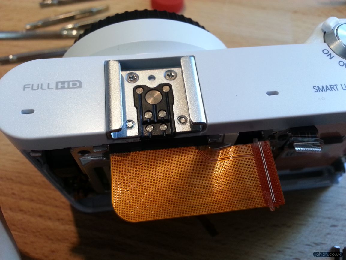 NX1000 - Screws hidden under the flash hotshoe